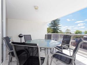 a patio with a table and chairs on a balcony at Nelson Towers, 9,71a Victoria Parade - unit in the heart of Nelson Bay with water views, air conditioning and Wi-Fi in Nelson Bay