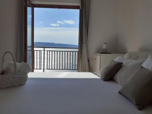 a bedroom with a white bed and a large window at Room Domo in Senj +20 photos