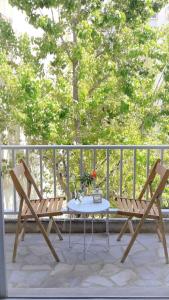 a table and two chairs sitting on a patio at Central, Bright and Comfortable Apartment with balcony in Athens