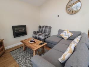 a living room with a couch and a table at Willow Lodge in Newcastle upon Tyne