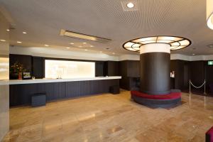 a lobby with a bar and a stage in a building at Kochi Hotel in Kochi