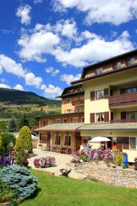 a hotel with a garden in front of a building at Residence Sci Sport in Bormio