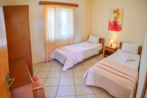 Ένα ή περισσότερα κρεβάτια σε δωμάτιο στο Villa Mimagia Apartments