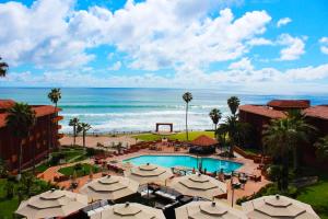 an aerial view of a resort with a pool and the ocean at Puerto Nuevo Baja Hotel & Villas in Rosarito +124 photos