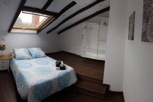 a bedroom with a bed with a teddy bear on it at Aptos Cama del Rey ideal parejas in Santander