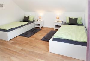 a bedroom with two beds and two night stands at FeWo Nelly Marie Wohnung Nelly in Hademstorf