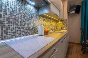 a kitchen with a counter top with a sink at Apartament Amelia in Ustrzyki Dolne