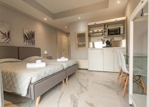 a bedroom with a bed and a kitchen at Mariposa Apartments next to the Sea in Sidari +35 photos