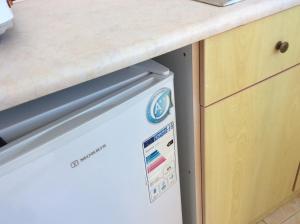 a dishwasher under a counter in a kitchen at Despoina Rooms in Plakias