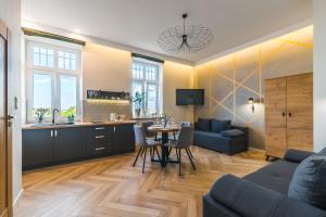 a kitchen and living room with a couch and a table at Panorama Przemyśl in Przemyśl