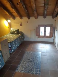 a bedroom with a bed and a tiled floor at Casa CARMA in Campillo de Ranas