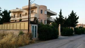 a building on the side of a street at Lovely 2-Bedroom Apartment At Greek Riviera in Vari