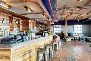 a restaurant with a bar with stools in it at Rock Apartments by Lowkl in Miami Beach