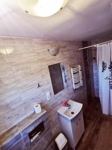 a bathroom with a white sink and a toilet at Morska Fala in Karwia +16 photos