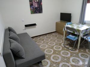 a living room with a couch and a table at loft turistic in San Vicente dels Horts