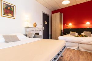 Postel nebo postele na pokoji v ubytování Hôtel des Bains