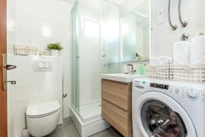 a bathroom with a washing machine and a shower at Jadrija Bay in Šibenik +8 photos