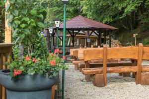 a group of benches and a gazebo with flowers at Landgasthof Hieren Mühle in Ney