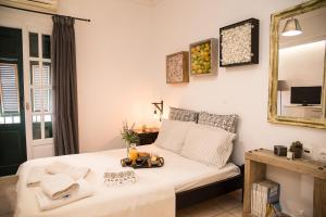 a bedroom with a bed with a tray of food on it at Mint Apartment Zakynthos Town Center in Zakynthos Town