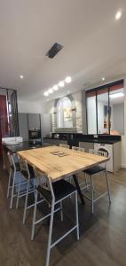 a kitchen with a large wooden table and chairs at galerie Angle3 in Quimper