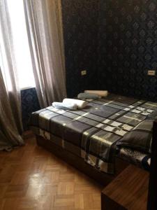 a bed sitting in a room with a window at Guesthouse Raisa in Kvareli