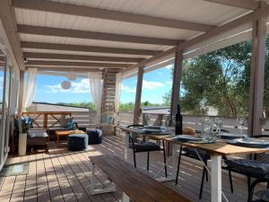a patio with tables and chairs on a deck at Mobile Home M&M in Drage