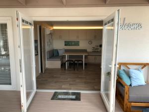 a view of a kitchen and a living room with a table at Mobile Home M&M in Drage