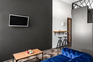 a living room with a blue couch and a table at River house apartments in Kaunas