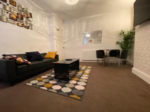 a living room with a couch and a table at Warwick Street Professional Lets in Newcastle upon Tyne