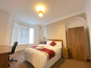 a bedroom with a bed and a desk and a chair at Warwick Street Professional Lets in Newcastle upon Tyne