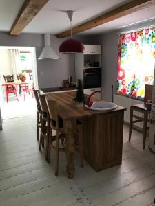 a kitchen with a wooden table and some chairs at Siedlisko U Źródeł in Skierbieszów