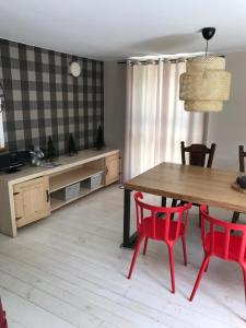 a kitchen with a wooden table and red chairs at Siedlisko U Źródeł in Skierbieszów +13 photos