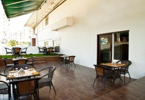a restaurant with tables and chairs on a patio at Octave Hotel & Spa - Sarjapur Road in Bangalore