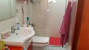 a bathroom with a sink and a toilet and a shower at Charming Oceanfront House in Puerto de Mogn, Gran Canaria in Puerto de Mogán