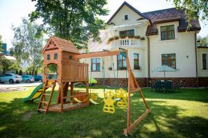 a playground in a yard in front of a house at Villa Garden Apartments in Poprad