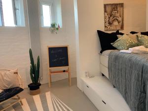 a bedroom with a bed and a chalkboard on the wall at Ystads Gamla Vattentorn in Ystad