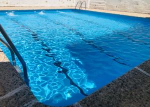 a swimming pool with blue water at NUEVA CAZORLA BELLA VISTA in Cazorla
