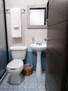 a bathroom with a toilet and a sink at Hotel Corazón Mexicano in Guanajuato