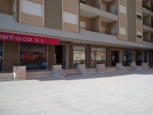 a building with a red car in the window at Casa de Praia da Lú in Figueira da Foz