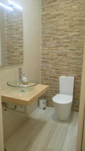 a bathroom with a toilet and a glass sink at RESIDENCIAL RITA in Odemira +26 photos