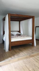a wooden bunk bed in a room with a wooden floor at L escapade amoureuse in Bournezeau