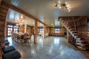 a large dining room with a table and a staircase at Brīvdienu māja "Avotiņš" in Līvāni