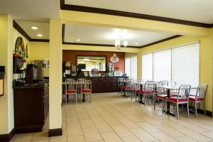 a dining room with tables and chairs in a restaurant at Super 8 by Wyndham Woodward in Woodward