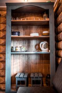 a wooden shelf with two benches in a kitchen at PIRTS NAMIŅŠ "Avotiņš" in Līvāni