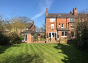 a large brick house with a large grass yard at Brand new apartment in Knutsford in Knutsford