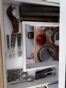 a drawer with utensils in a kitchen at Chez Pascal et Claudia in Kumak