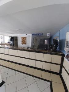 a restaurant with a counter in a room at Apart Hotel Marinas Tamandaré in Tamandaré