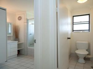 a bathroom with a toilet and a sink at Promenade 11, 8 Intrepid Close - air conditioned unit with beautiful water views in Shoal Bay +13 photos