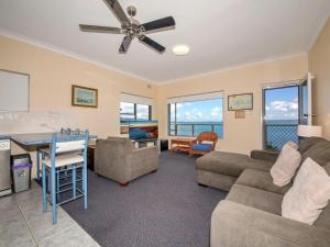a living room with a couch and a ceiling fan at Quarterdeck 5 panoramic water views and close to town in Nelson Bay