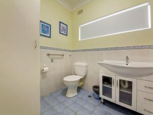 a bathroom with a white toilet and a sink at Quarterdeck 5 panoramic water views and close to town in Nelson Bay
